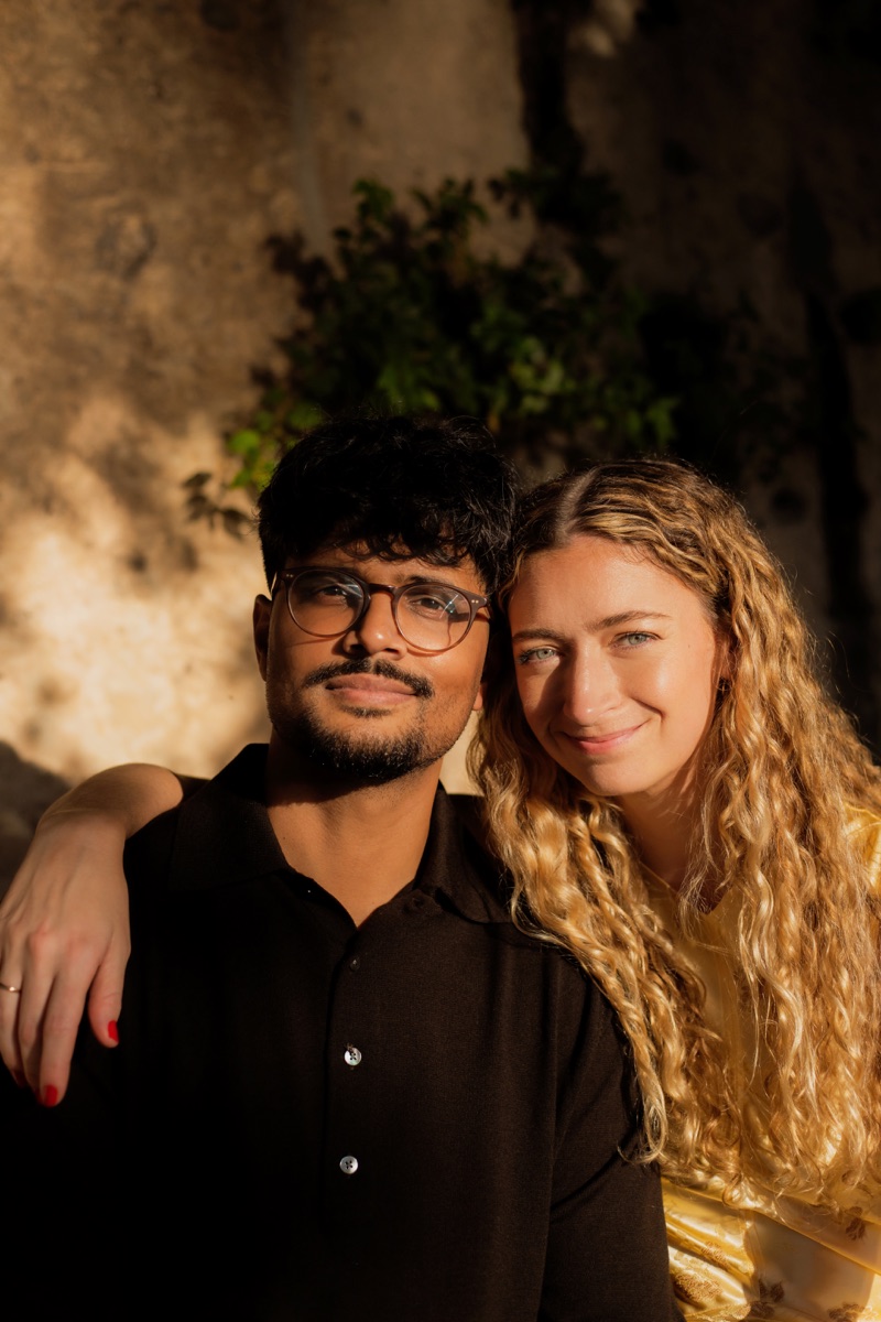 Madeline and Rondeep sitting close together in late sunlight